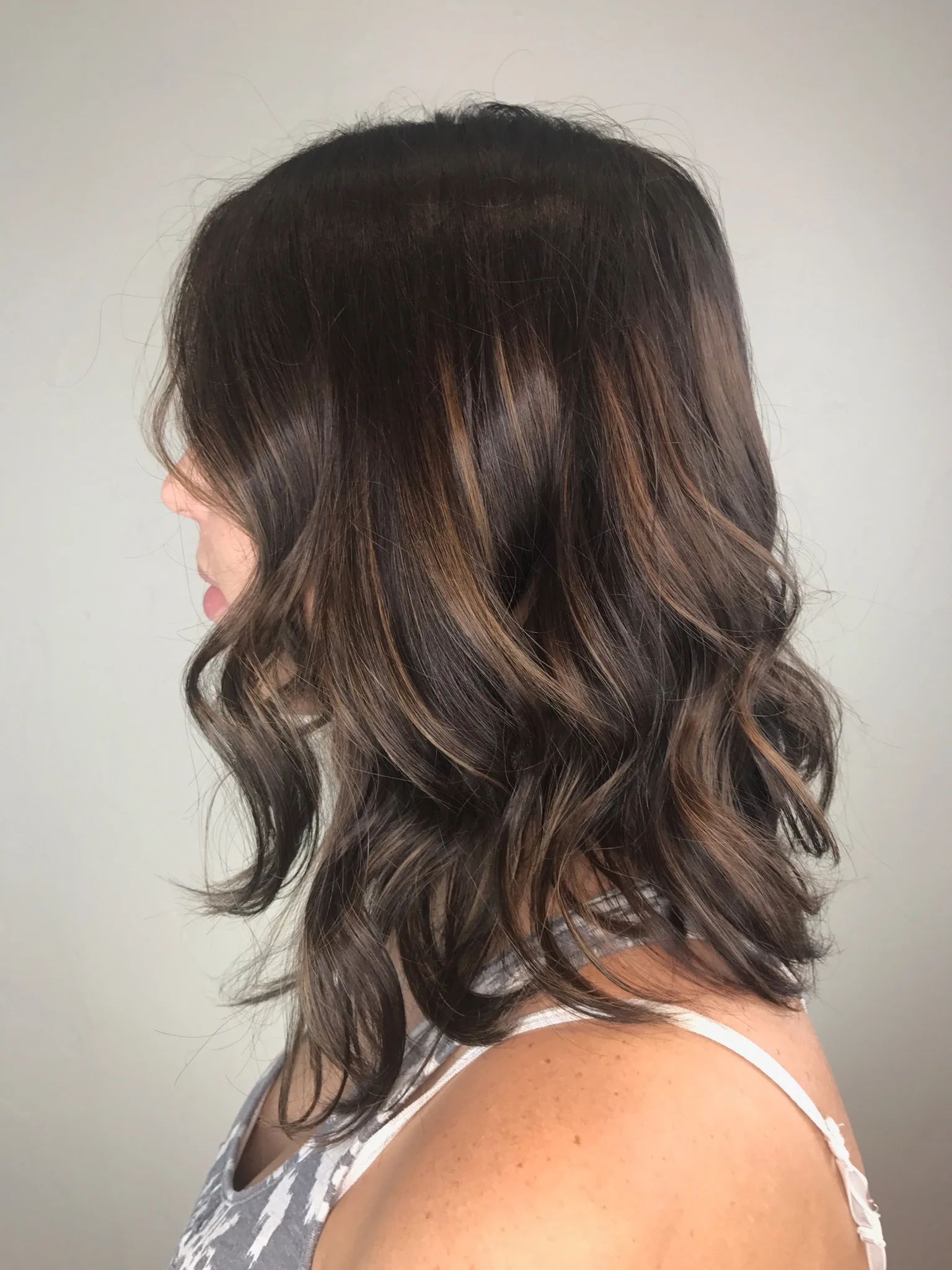 Caramel highlights woven through dark brown hair