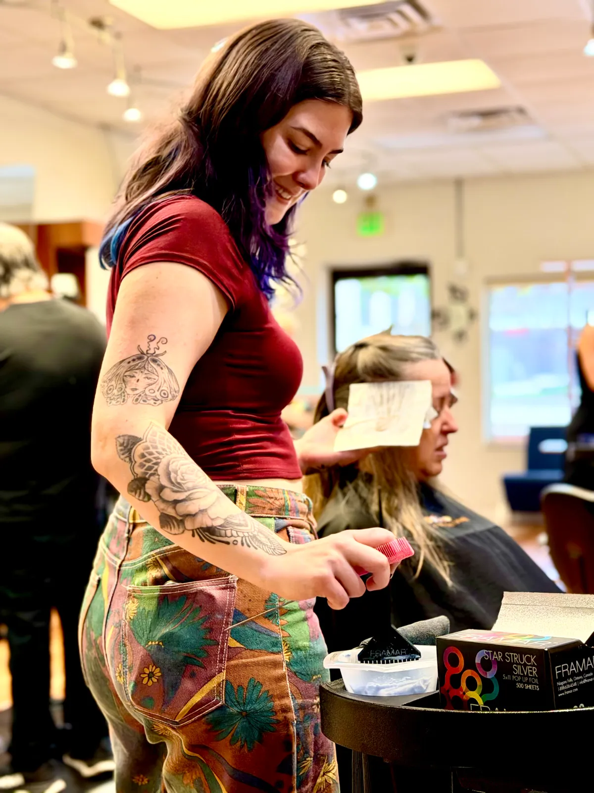 Anaya Lorenzini, Ciao Bella's certified curly specialist, working at her station