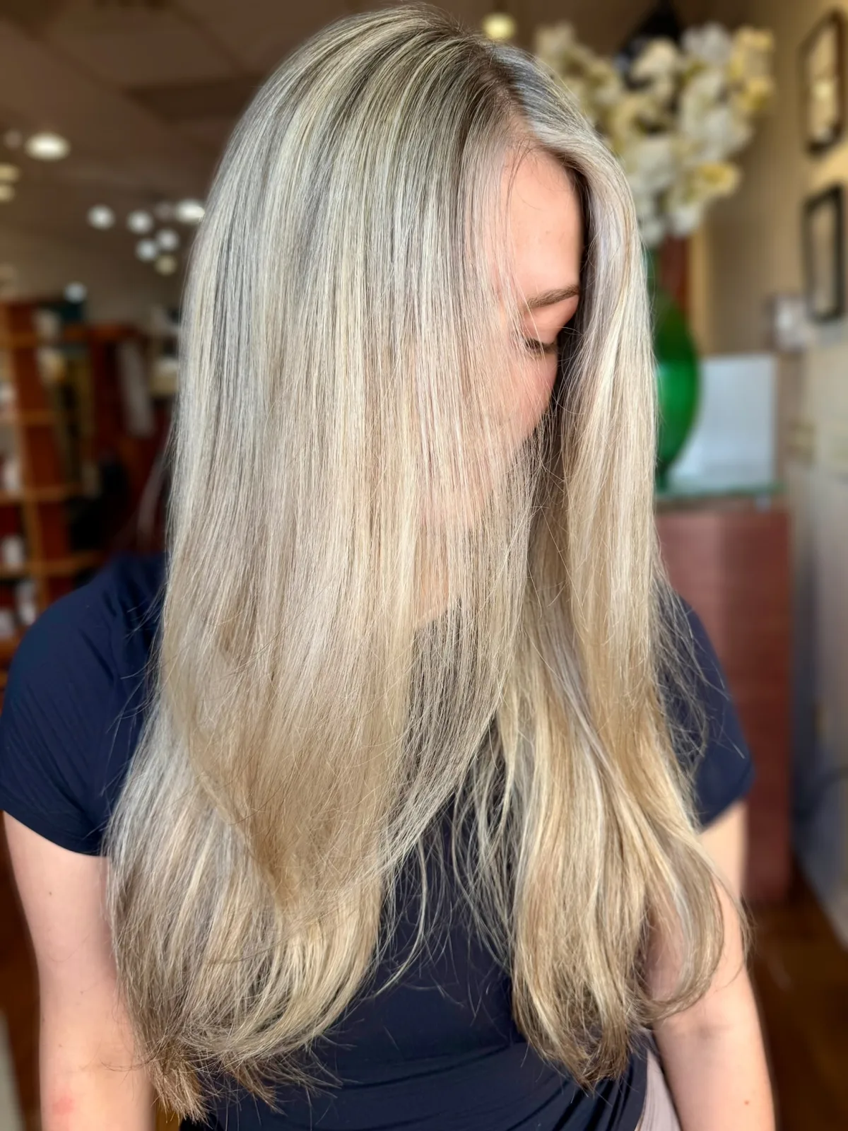 Cool ash blonde, straight and glossy, root to ends
