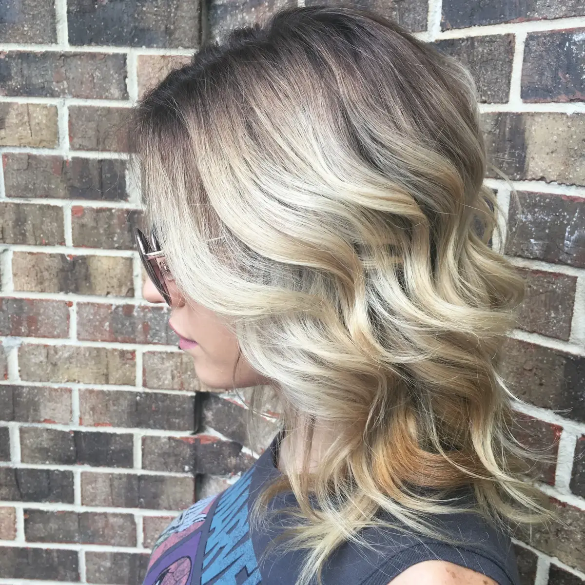Rooted blonde balayage with soft waves