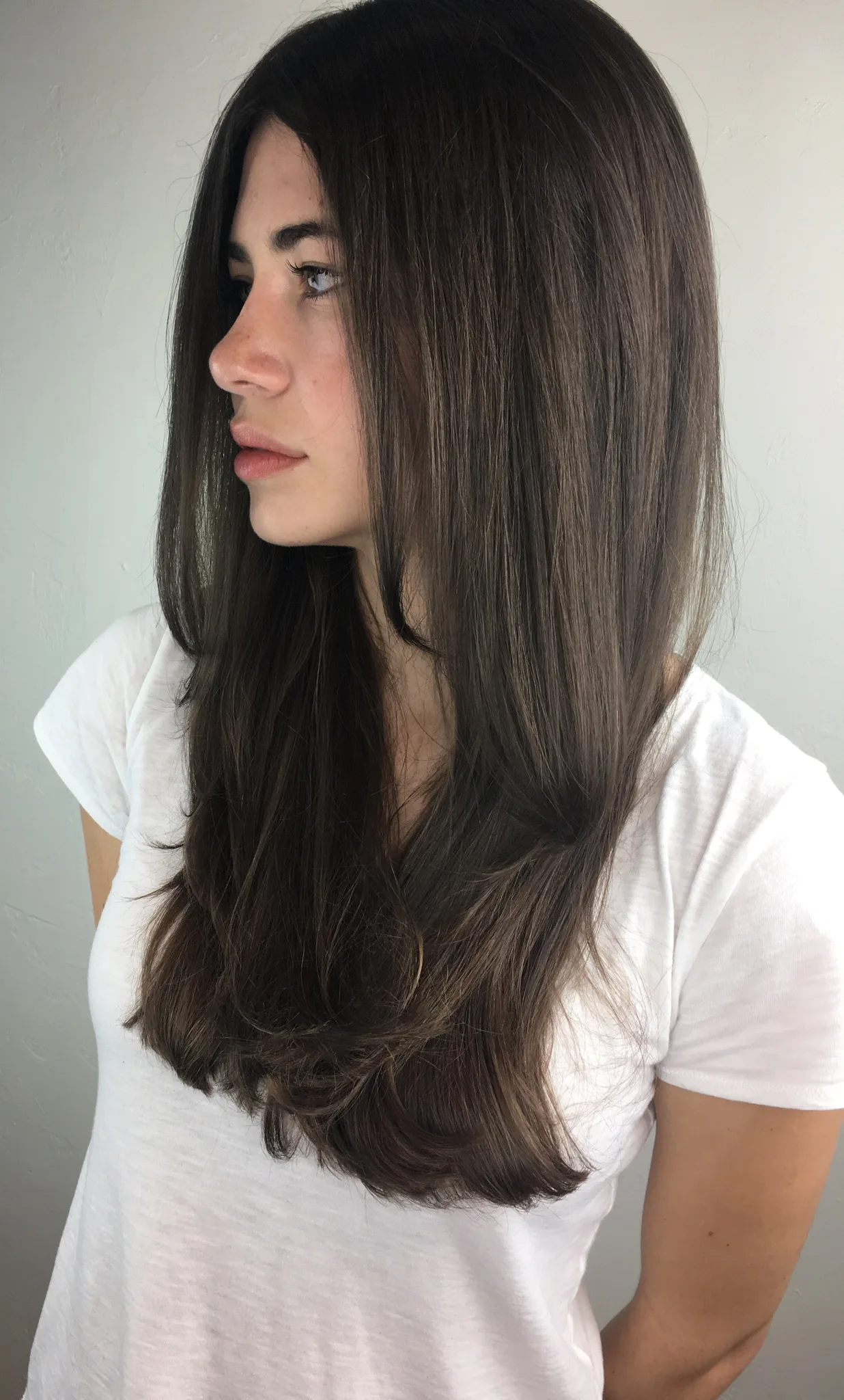 Brunette balayage with caramel dimension in soft curls