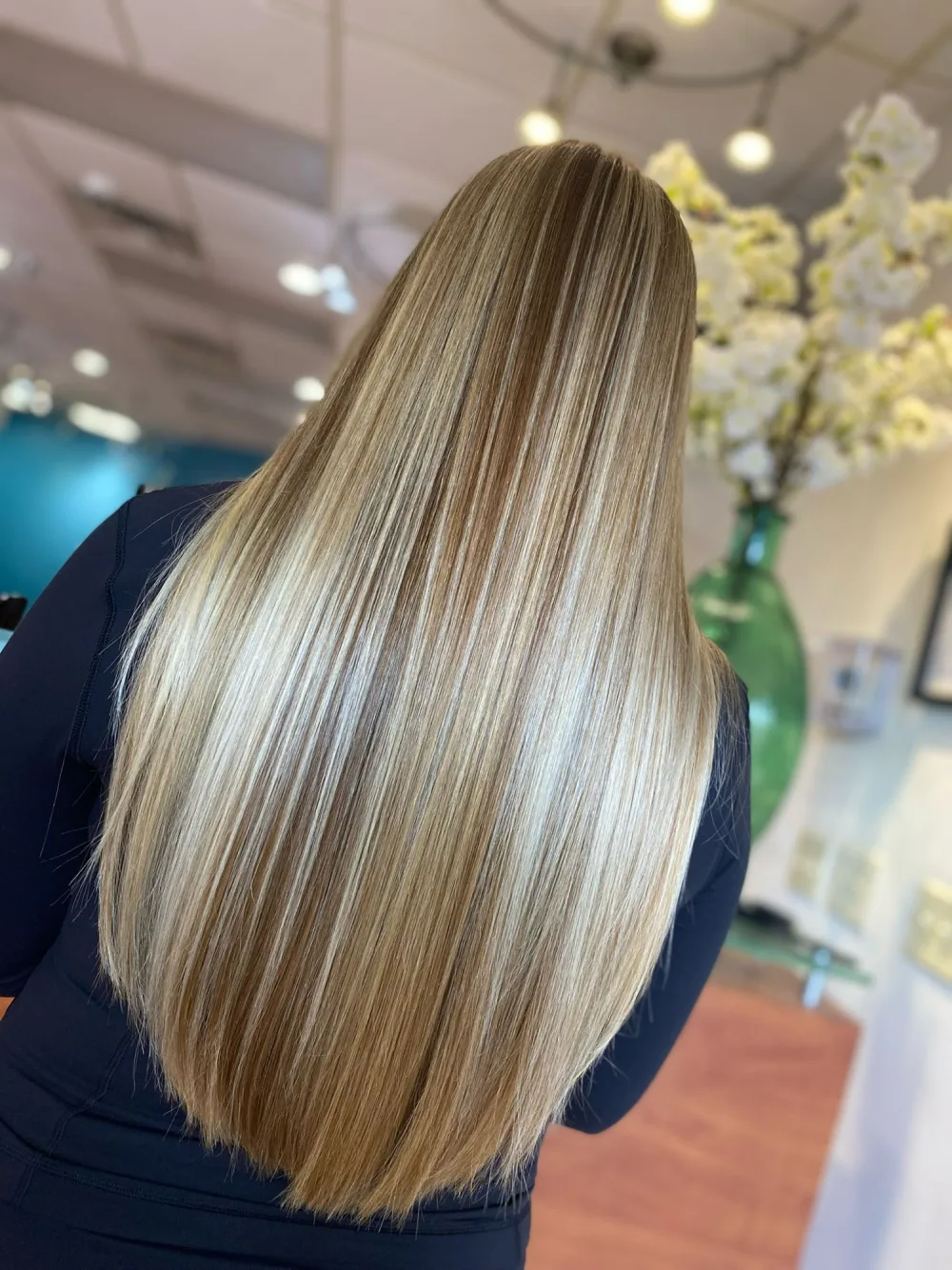 After color correction: bright, dimensional blonde with even tone and a glossy finish
