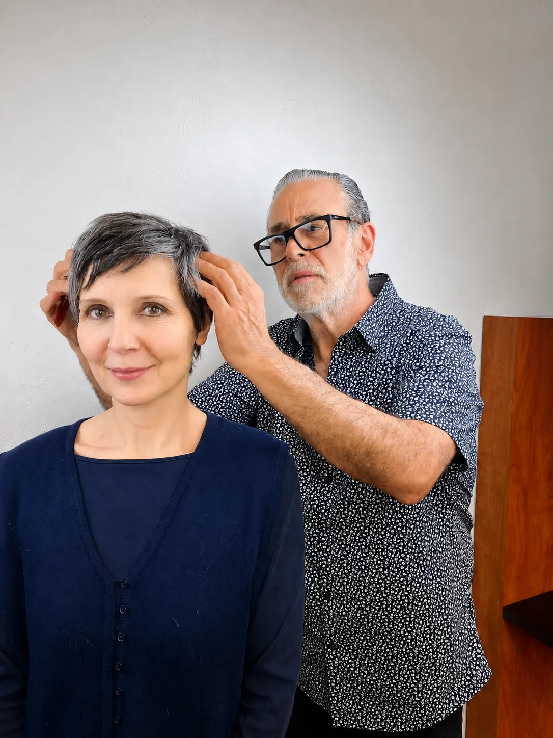 Michele Anzivino styling a guest's silver pixie cut with both hands at Ciao Bella Salon in Gainesville, Florida