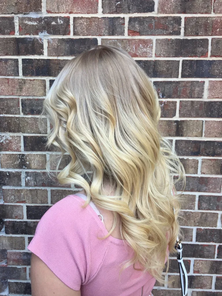 Bright pearl blonde balayage in soft bends