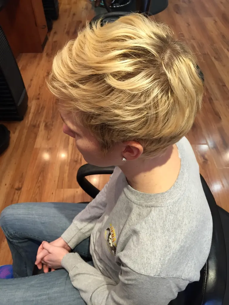 Overhead view of a blonde pixie cut showing the internal layering and piecey texture through the crown