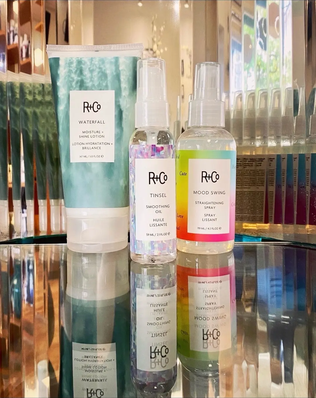 R+Co Waterfall lotion, Tinsel smoothing oil, and Mood Swing straightening spray on the glass counter at Ciao Bella
